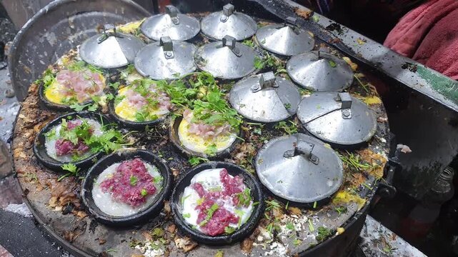 Cooking street food in Vietnam. Woman cooks food in frying pan. National Vietnamese cuisine