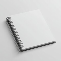 Blank spiral-bound notebook lying on a light surface.