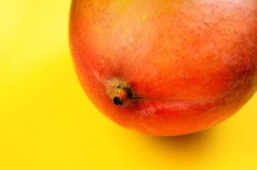 Close-up of a mango on a bright yellow background