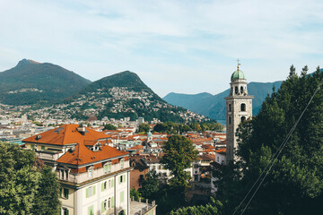 Fototapeta premium rooftop view of lugano city switzerland with hills and mountains on clear day