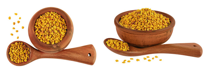 Bee pollen grains in wooden bowl and spoon isolated on white background. Top view. Flat lay