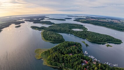 High altitude aerial shot of the Kisajno lake, one of the Great Masurian Lakes, at sunset. 