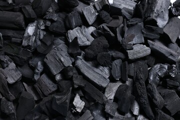 Pieces of black coals as background, top view