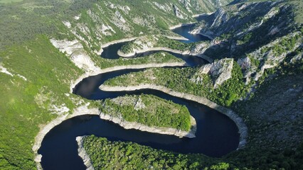 Aerial view of Uvac Canyon in Serbia. howcasing the dramatic meanders of the Uvac River. Steep...