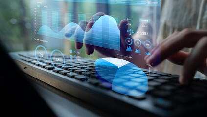 Image depicts a person using a keyboard while engaging with digital data displays, showcasing analytics and performance metrics in a contemporary office setting. Impute