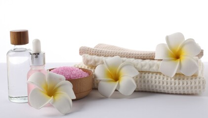 Spa composition with waffle towels and cosmetic products isolated on white