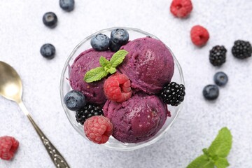 Delicious sorbet with fresh berries and mint in dessert bowl on grey textured table, flat lay