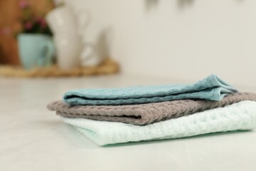 Clean waffle towels on white table, closeup