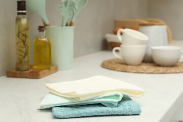 Waffle towels and dishware on white counter, closeup