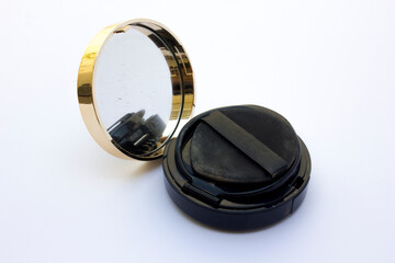 Black circular tube powder compact isolated on the white background.