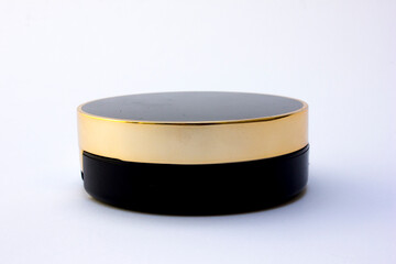 Black circular tube powder compact isolated on the white background.