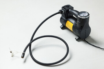 One modern tire inflator on light background