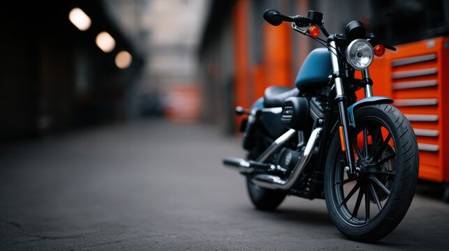 A blue motorcycle is parked in front of a red toolbox