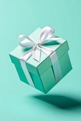 Obraz premium Floating Turquoise Gift Box with White Ribbon on Aqua Background, Minimalist Holiday Present for Celebration, Birthday, or Special Occasion