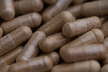 Close up of Light Brown Capsules Filled with Natural Supplement Powder