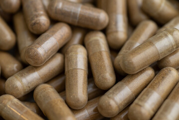 Close up of Light Brown Capsules Filled with Natural Supplement Powder