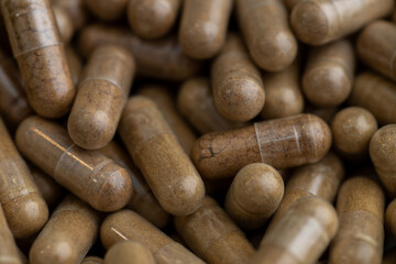 Close up of Light Brown Capsules Filled with Natural Supplement Powder