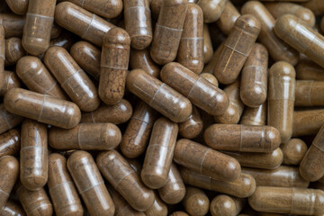 Close up of Light Brown Capsules Filled with Natural Supplement Powder