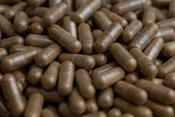 Close up of Light Brown Capsules Filled with Natural Supplement Powder