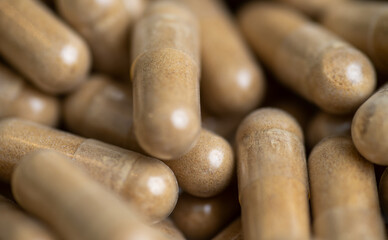 Close up of Light Brown Capsules Filled with Natural Supplement Powder