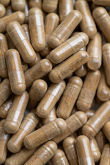 Close up of Light Brown Capsules Filled with Natural Supplement Powder