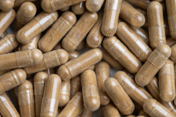 Close up of Light Brown Capsules Filled with Natural Supplement Powder