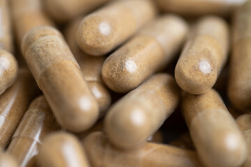 Close up of Light Brown Capsules Filled with Natural Supplement Powder