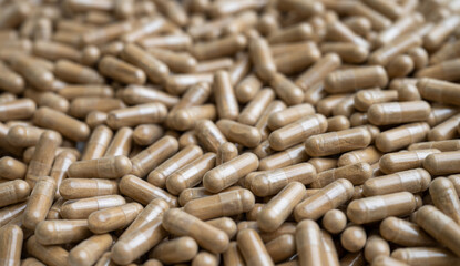 Close up of Light Brown Capsules Filled with Natural Supplement Powder