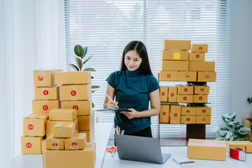 Young asian business woman startup sme small business entrepreneur SME distribution warehouse with...