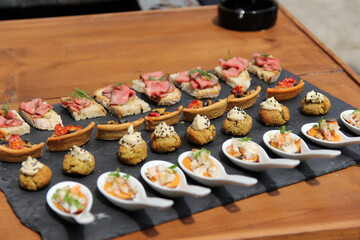 Colorful appetizers on black plate