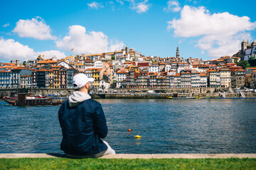 Serene Riverside Contemplation by the Majestic Historic Architecture of Porto Cityscape