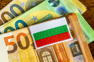 Accession of Bulgaria to the euro zone in 2026. The flag of Bulgaria and the Euro currency. Financial concept. close up