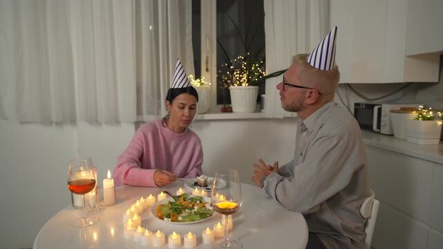 Birthday Couple Kitchen Candles - A couple celebrates a birthday in their kitchen with candles and a cake.