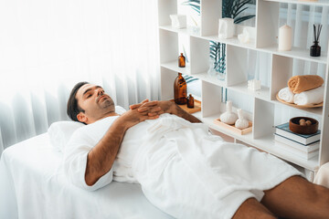 Caucasian man customer enjoying relaxing anti-stress spa massage and pampering with beauty skin...