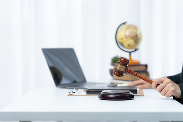 Justice in the Modern Age: A poised gavel signifies order amidst technology, a laptop standing...