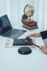 Judicial Workspace: A close-up shot of a judge's gavel, resting on a wooden sound block, poised...
