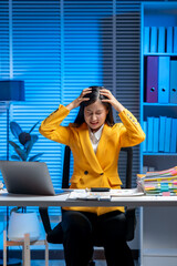 Stressful Night Shift: A determined individual, in a stylish jacket, appears overwhelmed at a desk...