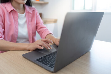 Digital Transformation: Woman typing on laptop at home office