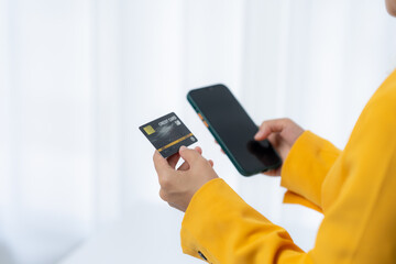 Mobile Payment and Digital Transaction:  Person in yellow clothes  is using smartphone to complete...