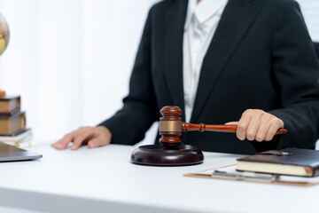 Legal Precision: A judicial professional in a formal suit, holding a gavel, symbolizing justice,...