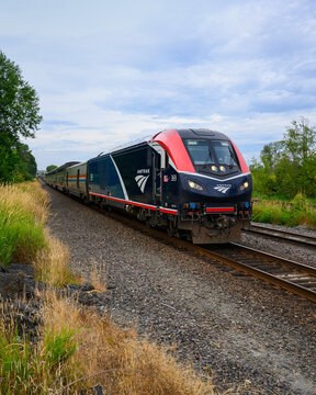 Everett, WA, USA - August 5, 2025; Amtrak Empire Builder passing in closeup with sleeper train from Seattle to Chicago