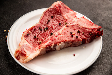 Raw steak T-bone fresh meat premium beef snack fresh delicious gourmet food background on the table rustic food top view copy space