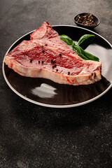 Raw steak T-bone fresh meat premium beef snack fresh delicious gourmet food background on the table rustic food top view copy space