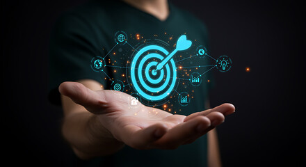 A digital target with an arrow hitting the bullseye is displayed in a mans hand, representing business success, goal achievement, and strategic marketing in technology