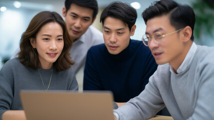 Professional Asian Team Collaborating on Project Planning in Office