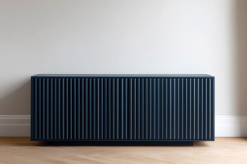 A dark blue fluted sideboard in modern interior standing against a neutral wall on light wood flooring