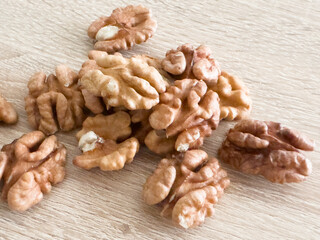 Peeled walnuts. On a wooden board. Healthy food. Natural background.
