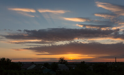 Landscape at sunset. Tragic gloomy sky. Panorama. Crimson twilight.