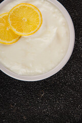Lemon yogurt natural product skyr sour milk skir fresh delicious gourmet food background on the table rustic food top view copy space keto and paleo diet vegetarian food