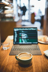 Cozy Urban Coffeehouse Vibe with Laptop for Coding and Relaxing Moments in a Warm Café Environment